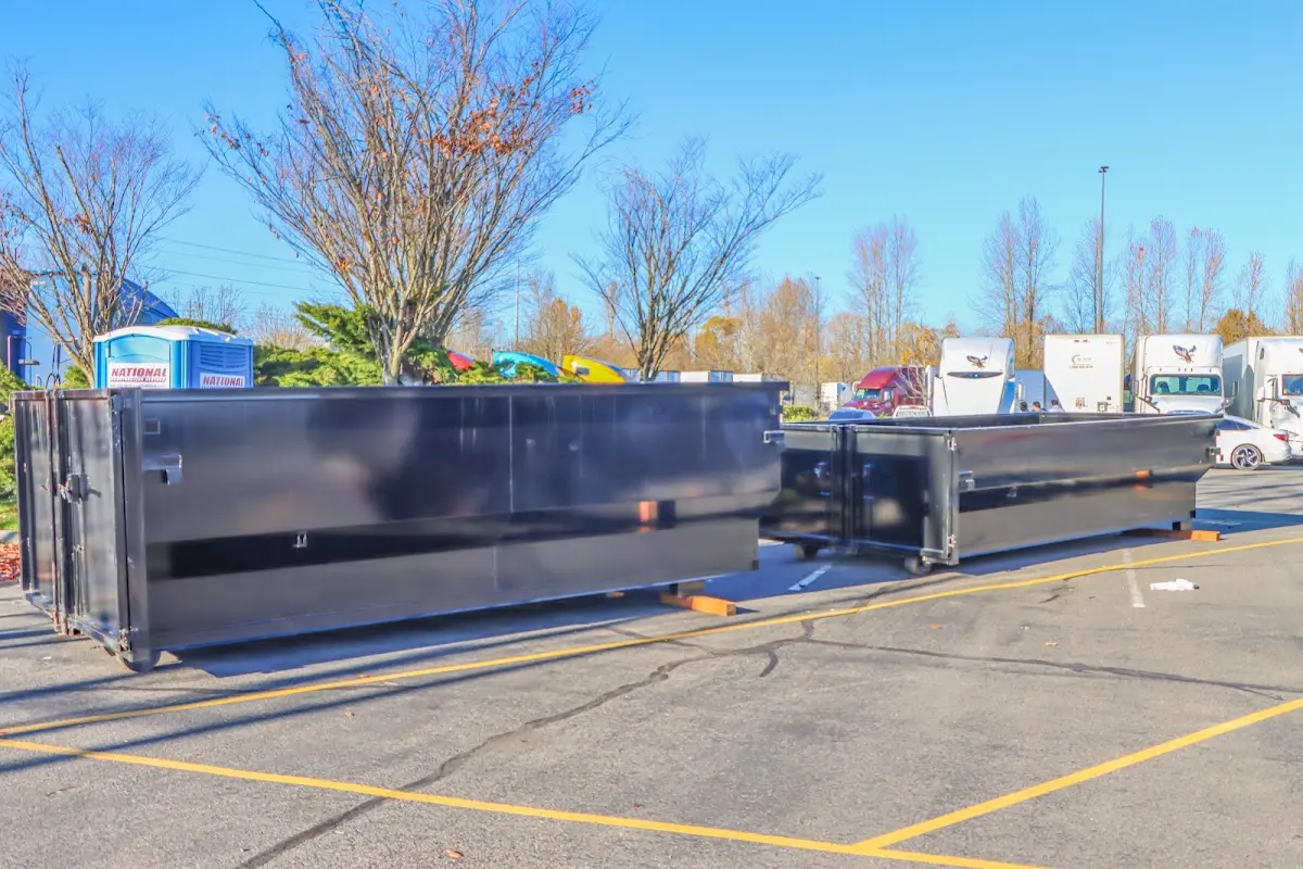 Professional dumpster rental service with roll-off container on residential driveway in Souderton